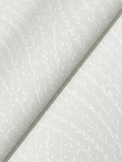 Willow Song Botanical Wallpaper by York Wallcoverings features a subtle, delicate leafy branch pattern in a matte finish, arranged diagonally across a white background. The design offers a soft, elegant, and minimalistic look.