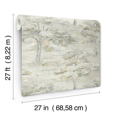 A roll of Moreno Woodland Wallpaper by York Wallcoverings, featuring a soft, muted tree landscape design and shown unrolled to display the pattern. Dimensions are 27 feet by 27 inches (8.22 meters by 68.58 centimeters).