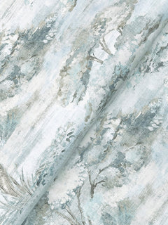 Moreno Woodland Wallpaper by York Wallcoverings features a light blue and green watercolor-inspired design with a subtle tree and foliage motif, showcasing soft brush strokes for an artistic, textured appearance.