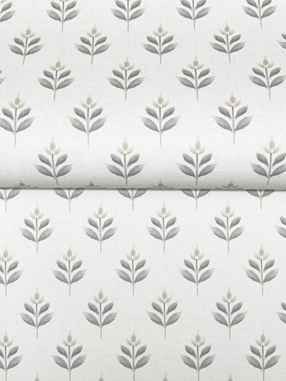 Serene Villa Floral Stamp Wallpaper by York Wallcoverings showcases a repeating pattern of simple, stylized gray and beige floral shapes with stems and leaves, printed on a crisp white background. The wallpaper is pictured folded, emphasizing the seamless continuity of its elegant design.