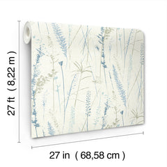 Meadow Splendor Botanical Wallpaper features a delicate pattern of blue and green plants on a cream background and comes in a roll measuring 27 feet by 27 inches (8.22 m by 68.58 cm).