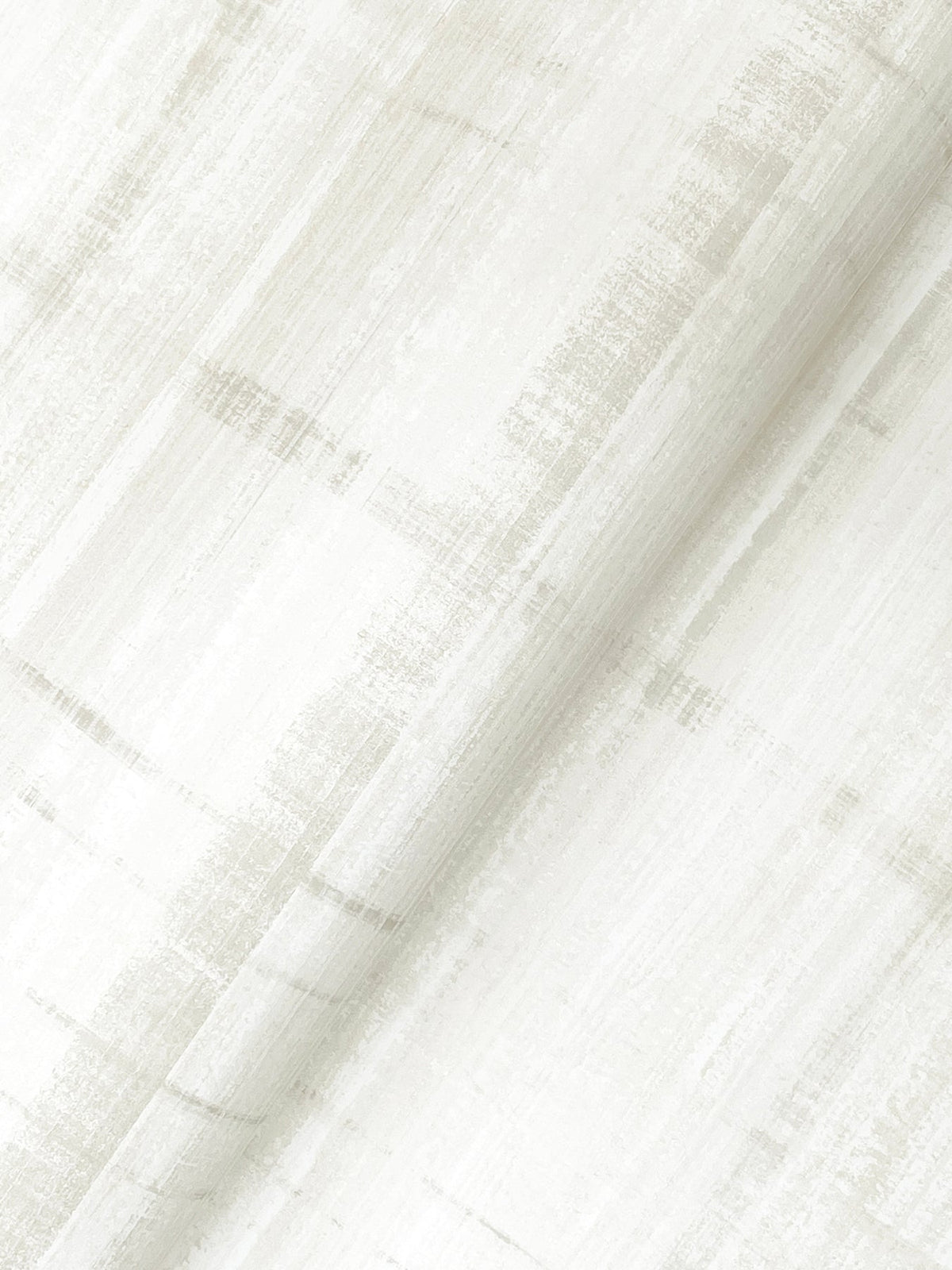 A close-up of Vanishing Point Striated Wallpaper by York Wallcoverings showcases its white surface adorned with a subtle, textured linear pattern in light gray, creating a soft, brushed effect. The wallpaper is gently folded, adding depth and shadow to the image.