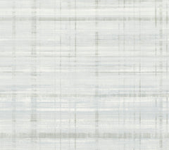 York Wallcoverings’ Vanishing Point Striated Wallpaper features a light gray and white abstract background, highlighted by subtle horizontal and vertical brushstroke lines that create a softly textured plaid or linen fabric effect.