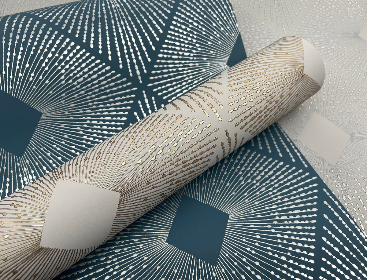 A close-up of the Harlowe Wallpaper by York Wallcoverings, featuring a geometric pattern of radiating gold and silver lines on a dark blue and white background.