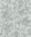 Shimmering Foliage Wallpaper by York Wallcoverings features a subtle, abstract illustration of tree branches and leaves in muted gray and pale blue tones, creating a soft, textured pattern on a light background.