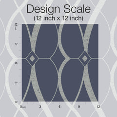 Here’s a rewritten version using the provided product data: The Graceful Geo Wallpaper by York Wallcoverings features a 12-inch by 12-inch square sample with curving lines and diamond shapes set against a dark blue background. Inch markers run along the left and bottom edges as a scale, with “Design Scale” labeled above.