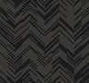 The Polished Chevron Wallpaper by York Wallcoverings features a repeating pattern of thin gold lines forming V-shaped chevrons on a sleek black background, creating a bold zigzag geometric design throughout.