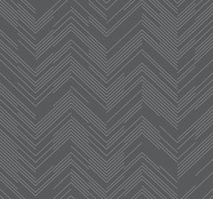 The Polished Chevron Wallpaper by York Wallcoverings features a repeating chevron design composed of thin white lines set against a dark gray background, producing a striking zigzag effect throughout the pattern.