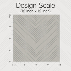 A 12 inch by 12 inch square sample of Polished Chevron Wallpaper by York Wallcoverings, featuring gray and white diagonal lines in a chevron pattern; the design scale (12″ x 12″) is labeled, with grid lines and inch markers along the left and bottom edges.