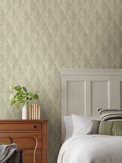 Magnolia Home Challenger Wallpaper with a neutral, textured chevron pattern behind a bedroom scene with a wooden nightstand and white bed.