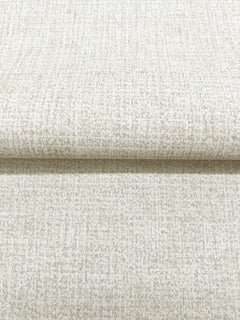 A roll of neutral Magnolia Home Brindled Wallpaper featuring a fine, brindled texture.