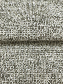 Folded sheet of Magnolia Home Brindled Wallpaper featuring a mottled, grid-like pattern in shades of brown and off-white.