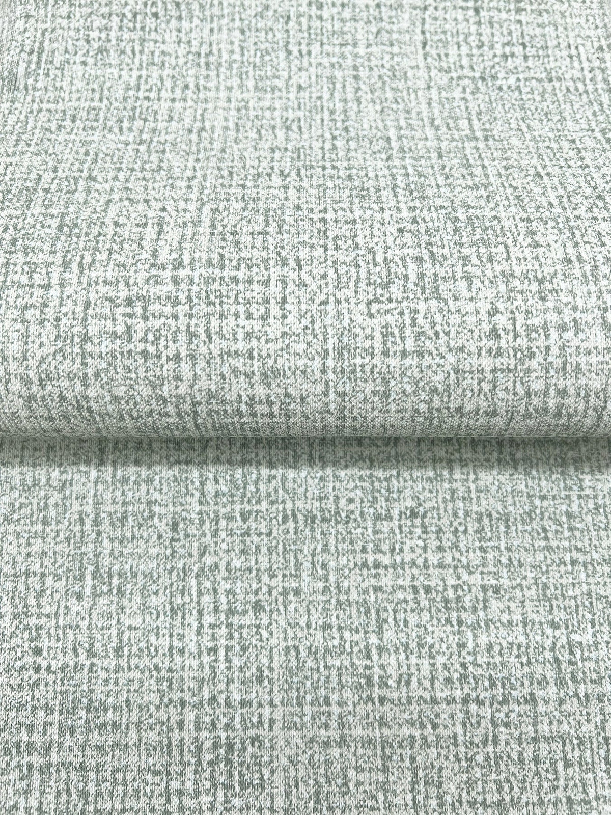 Magnolia Home Brindled Wallpaper in light gray featuring a subtle, dark gray grid pattern and a textured appearance.
