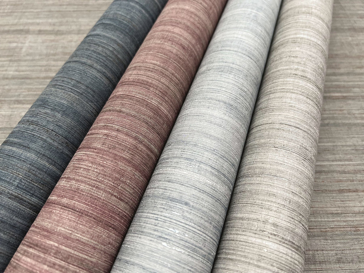 Four rolls of Tasar Silk Wallpaper with horizontal textured lines in shades of dark gray, reddish-brown, light gray, and beige.
