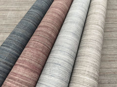 Four rolls of Tasar Silk Wallpaper with horizontal textured lines in shades of dark gray, reddish-brown, light gray, and beige.