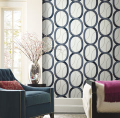 Candice Olson Interlock Wallpaper featuring a repeating pattern of dark blue interlocking oval rings on a light, textured background.