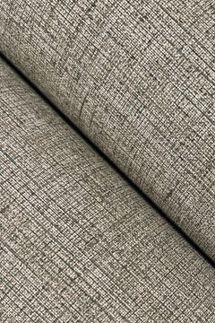 Close-up of Hardy Linen Wallpaper by York Wallcoverings, showcasing its textured, beige surface with a woven, grid-like pattern. The wallpaper is folded diagonally, creating a visible crease and shadow across the image.