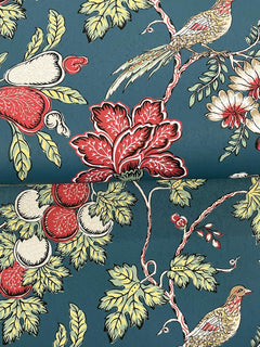 The Parterre Jacobean Wallpaper by York Wallcoverings features a vibrant teal blue background adorned with red, white, and green floral motifs, leafy branches, and two colorful birds perched among the foliage.