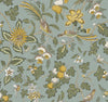 Parterre Jacobean Wallpaper by York Wallcoverings features an intricate, vintage botanical design with stylized yellow, white, and green flowers, leafy branches, and birds set against a muted blue-green background.