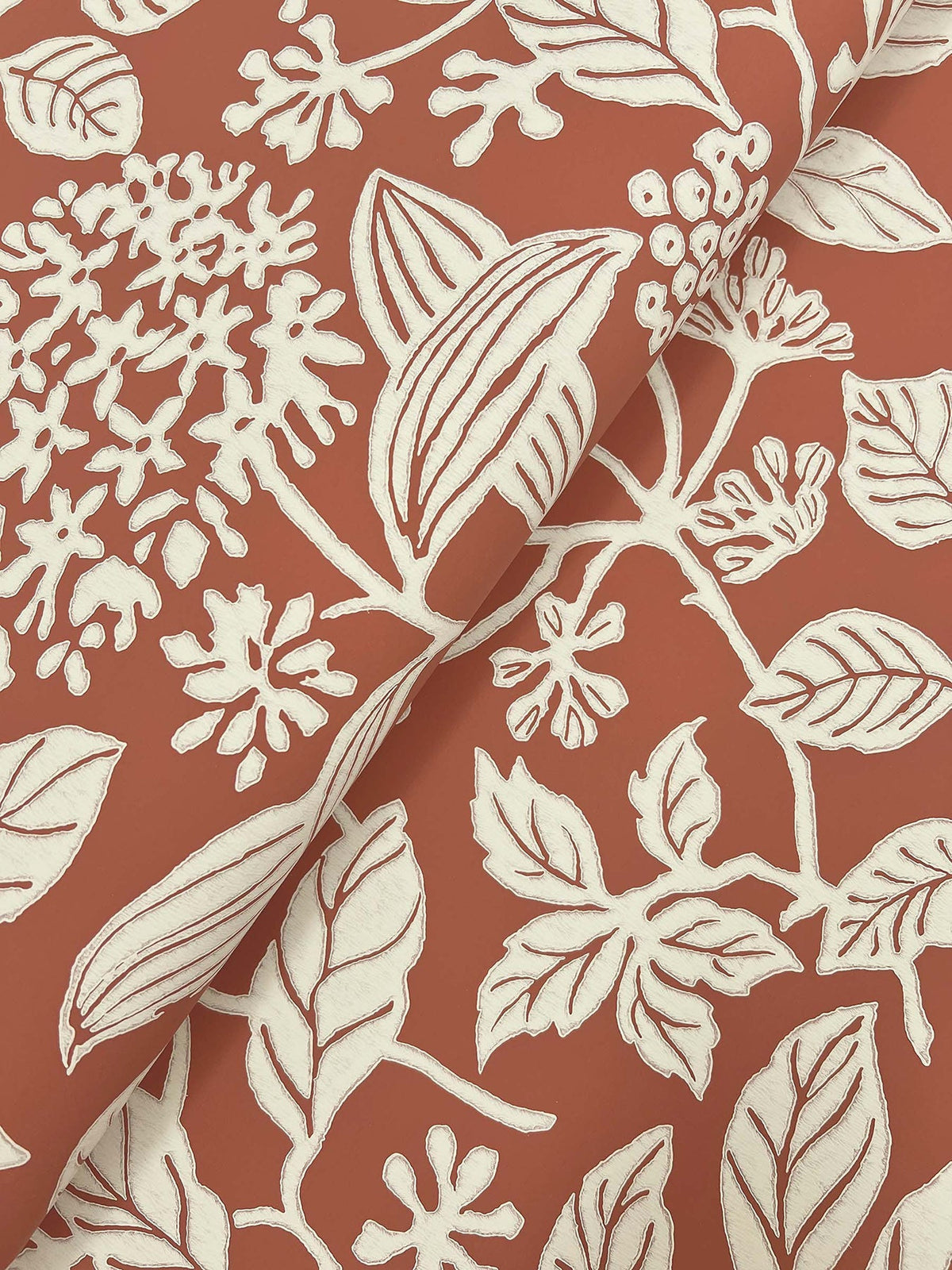 The Rowen Botanical Wallpaper by York Wallcoverings features overlapping white floral and leaf patterns on a textured reddish-brown background, with visible line details that accentuate its botanical design.