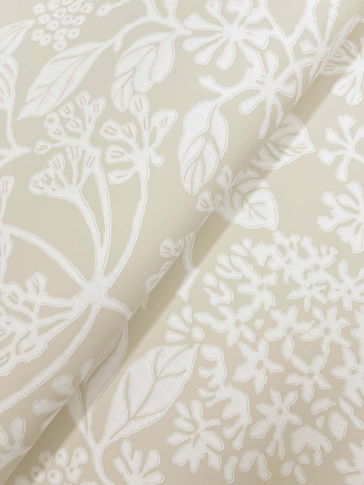 Introducing Rowen Botanical Wallpaper by York Wallcoverings—a cream-colored wallpaper showcasing an embossed white floral and leaf pattern with intricate stems, blossoms, and overlapping designs. Soft shadows add depth, beautifully enhancing its textured effect.