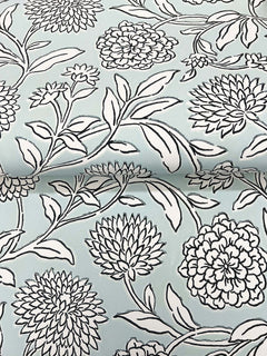 Chatsworth Garden Floral Trail Wallpaper by York Wallcoverings features a light blue background adorned with a white and black outlined botanical design of large, detailed blossoms and leafy branches, creating a bold and graphic floral motif.