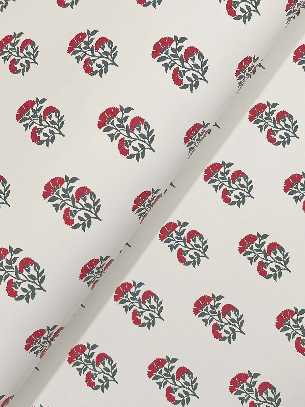 Sylvie Floral Wallpaper by York Wallcoverings features a white background adorned with small clusters of red flowers and green leaves, arranged in evenly spaced rows, with the wallpaper shown partially folded at an angle across the image.
