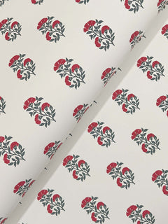 The “Sylvie Floral Wallpaper” by York Wallcoverings features a repeating pattern of red and green floral clusters on a white background, displayed here partially folded at an angle.