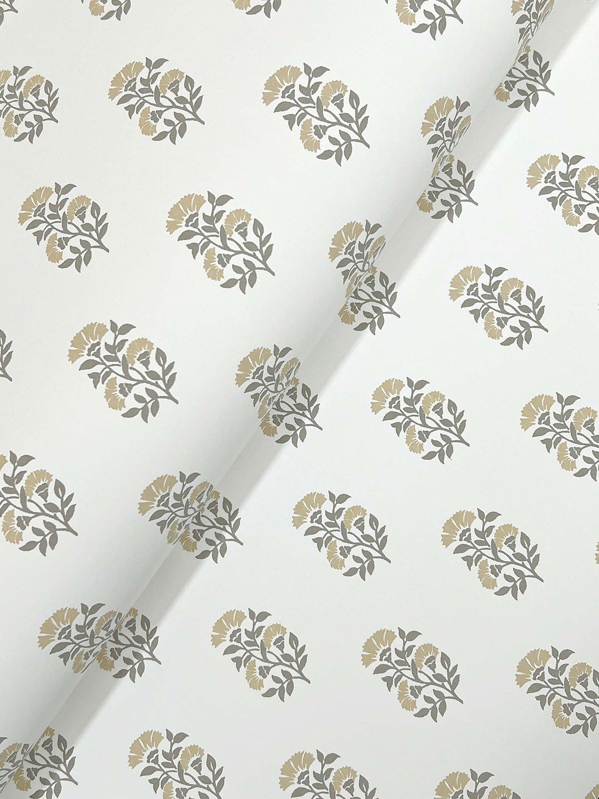 A sheet of Sylvie Floral Wallpaper by York Wallcoverings, featuring a repeating floral pattern in gray and beige on a white background, is shown at an angle with a visible fold running diagonally across the image.