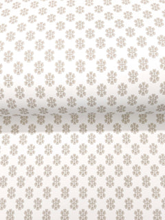 Brioni Floral Stamp Wallpaper by York Wallcoverings features a rolled white wallpaper adorned with a repeating pattern of small, light brown four-petal flowers evenly spaced across the surface.
