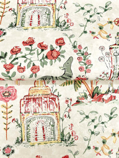 Parc Garden Dreams Wallpaper by York Wallcoverings features a playful, hand-painted pattern of whimsical scenes on a cream background, including pink flowers, leafy vines, stylized yellow-pink buildings, a green lizard, and small birds in a charming repeat.