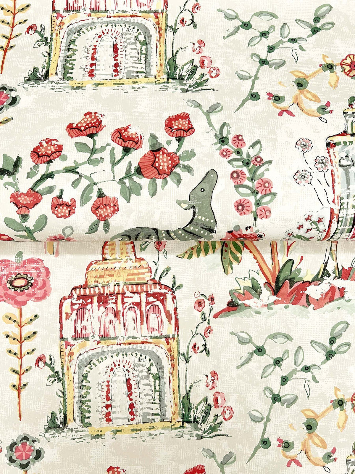 Parc Garden Dreams Wallpaper by York Wallcoverings features a whimsical watercolor design of domed buildings, blooming red flowers, leafy branches, and small birds set against a light background.