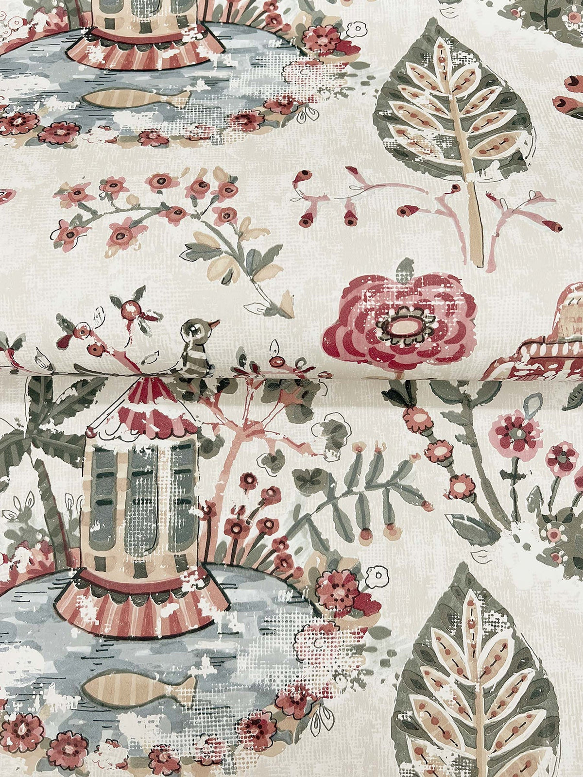 Parc Garden Dreams Wallpaper by York Wallcoverings features whimsical, garden-inspired designs with a charming gazebo, vibrant red flowers, green leaves, and tranquil water accents. The detailed pattern showcases colorful hues of pink, red, green, and blue, evoking a vintage botanical aesthetic.