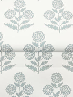Souci Marigolds Wallpaper by York Wallcoverings features a repeating pattern of stylized blue-gray flowers with round clusters and leafy stems on a white background, displayed here on a partially rolled sheet.