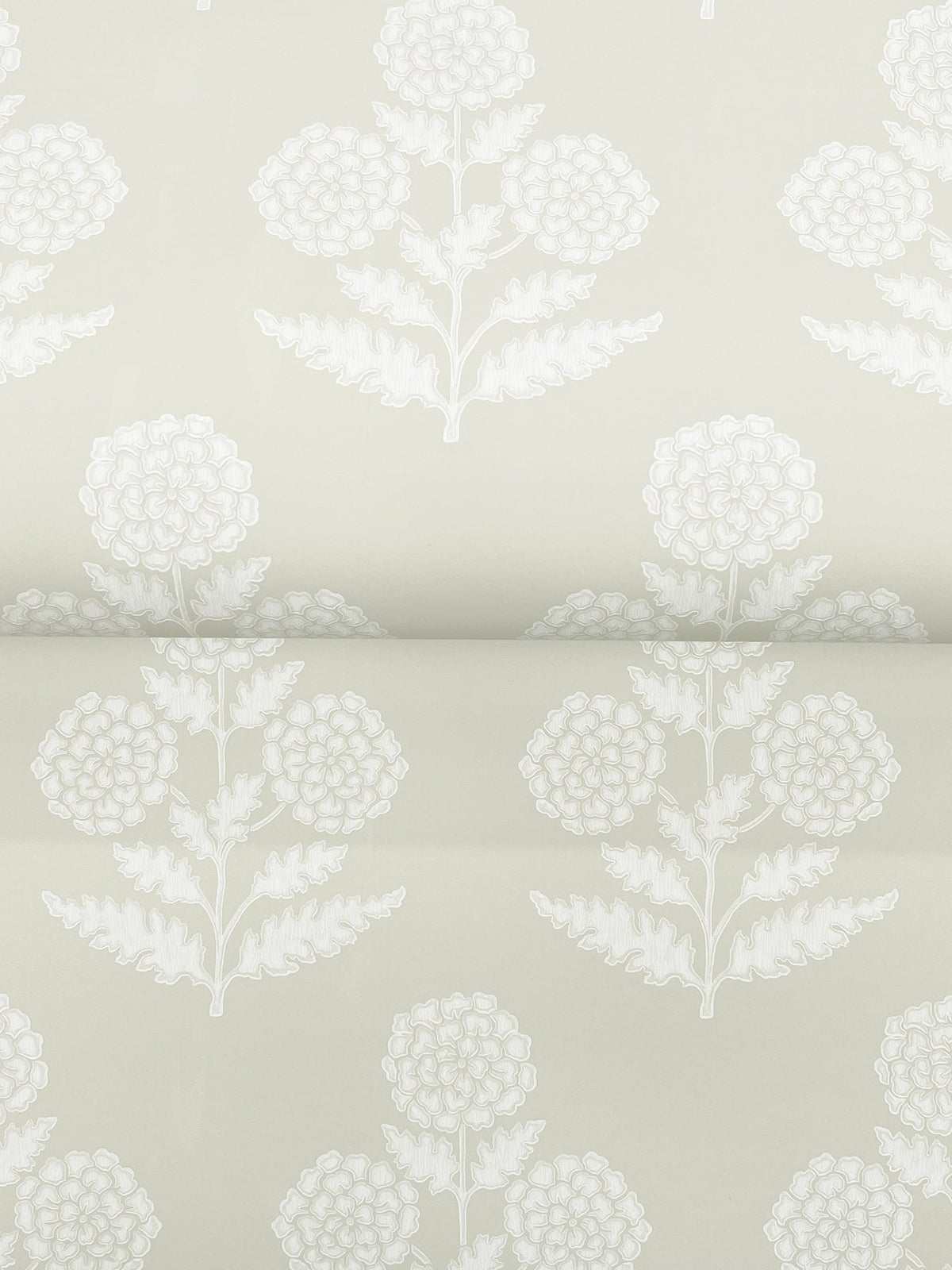 Souci Marigolds Wallpaper by York Wallcoverings features a light gray background adorned with repeating white floral motifs of stylized flowers and leaves arranged in a vertical, symmetrical pattern. The delicate design creates an elegant and understated botanical look.