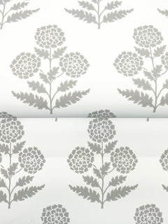 Souci Marigolds Wallpaper by York Wallcoverings features a gray floral pattern with symmetrical flowers and fern-like leaves on a white background, printed with a visible horizontal seam across the middle.